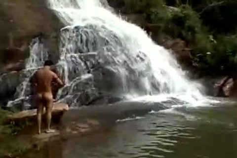 Three teens butt poke below A Waterfall